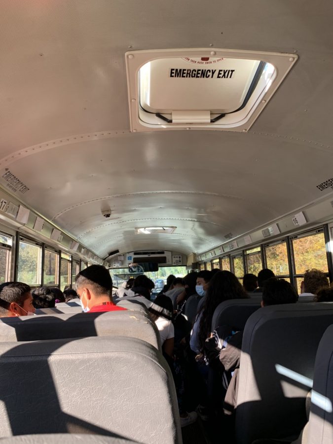 Students going home as they ride the bus showing the inside part.