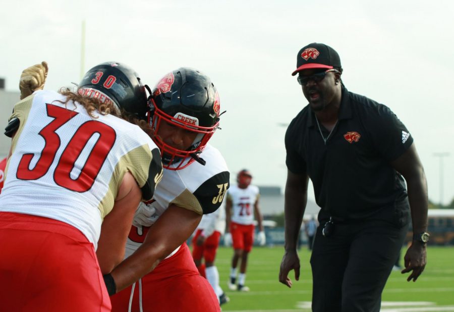 Coach Young yells at Brandon Lewis (12) and Daylin Manning (11 ) pre-game run throughs. 