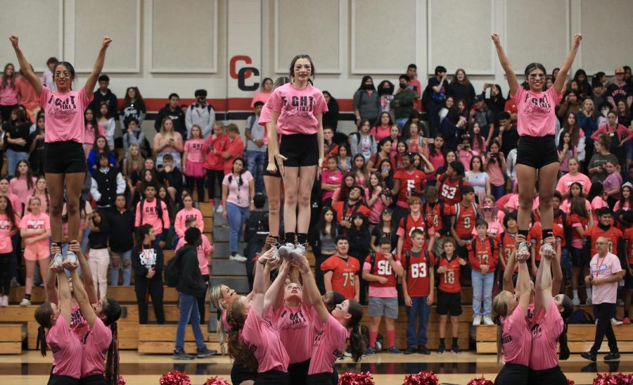GO, FIGHT, WIN. Caney Creek cheerleaders perform a stunt at the pink out pep rally on October 14, 2022. 