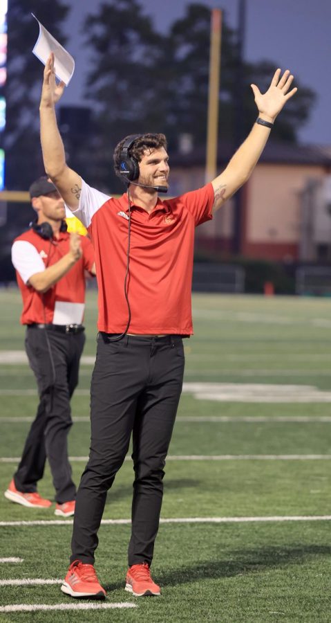 TOUCHDOWN. Chris Malott throws his hands up in a touchdown motion as the varsity football
team scores at the homecoming football game on Friday, Sept. 23. Malott coaches the receiver
on the Panther varsity football team. Mallet started coaching in 2018 at Mance Park Middle
School, he then moved to Moorhead Junior High before coaching at Caney Creek. “I was excited,
I am always excited for games. Whenever we do something positive, to me it feels better seeing
them do better than I ever did,” Malott said. “I suppose I am doing something good; it is so much
better seeing the kids that you are coaching do it.”
