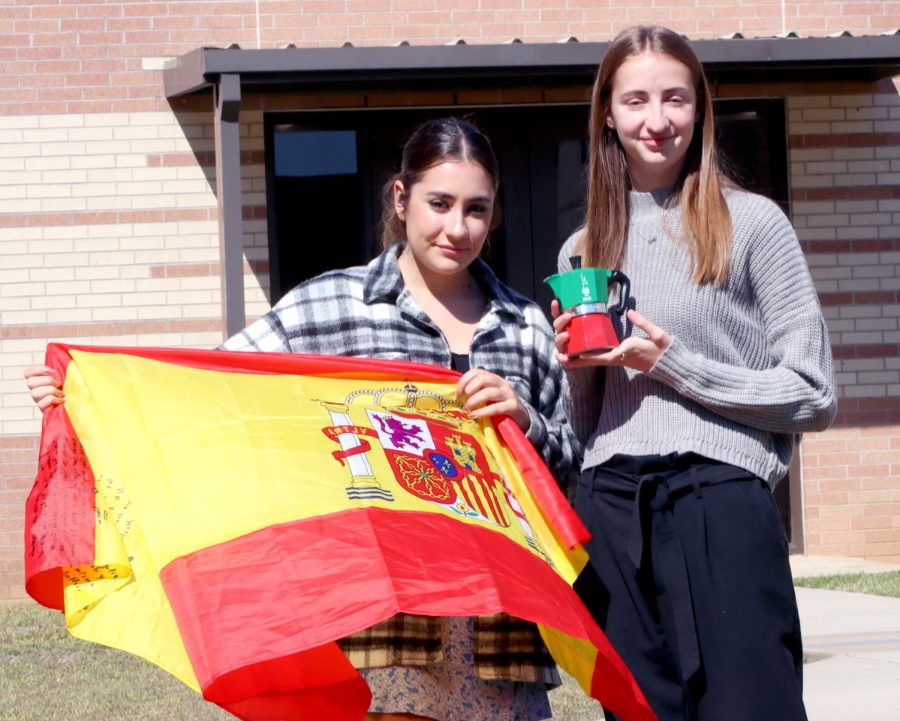 THE AMBIENCE.Senior Sofia Franceschi and Junior Maria Sopreda Montellia pose for a picture with their meaningful objects from their homeland on Feb. 22, 2022. After traveling here the students have gone through some great experiences. Although theyre living their dreams theres still the reminisce of their home. “The object I brought was an Italian colored moka coffee maker, it reminds me of Sunday mornings when my family and I used to eat breakfast together.” Franceschi said. Montillas object was a Spanish flag ‘’My family gave me it for my goodbye party, it represents who I am,’’ Montilla said. ‘’The whole ambience of Spain was amazing.” 

