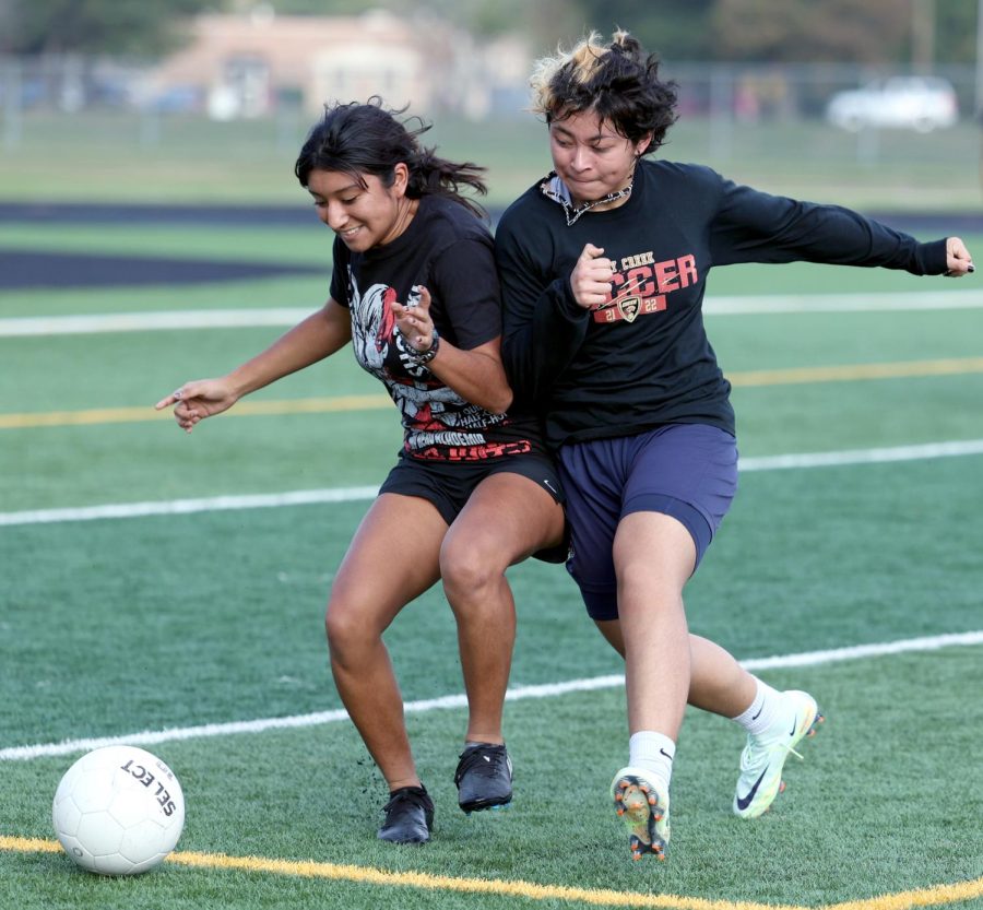 BUILDING UP PRESSURE. Senior Ale Aguilar pushes off junior Yensi Vasquez as they compete for the ball in a drill on the second day of tryouts on Wed. 29, 2022 on the Caney Creek turf.They’ve dealt with pressure in the tryouts, but feel excited for what comes for them in the upcoming season. “It’s very scary, theres a lot of harder schools this year,” Vasquez said. Aguilar mentioned, “I feel excited. I’m ready to take these new teams and show them who we are.” 
