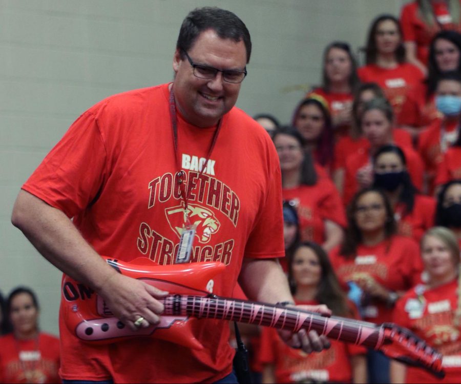 Principal Dr. Jeff Stichler rocks out during an air-guitar contest at the Meet the Panther pep rally for employees in the Caney Creek feeder zone on Aug. 6, 2021. 