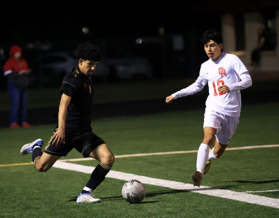 Senior Uriel Silva takes on an Oak ridge defensive player at Caney Creek High School on Mar. 14, 2023. This was Silva’s last home game of the season and managed to score a point in favor of the team. “I was excited for the end of the season, and I wanted to finish it off good,” Silva said “It felt amazing to score on my senior night with my parents in the stands cheering for me.”
