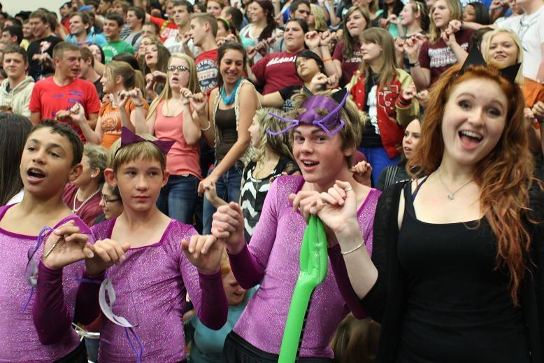 Creek Squad members hold pinkies during the singing of the school song.