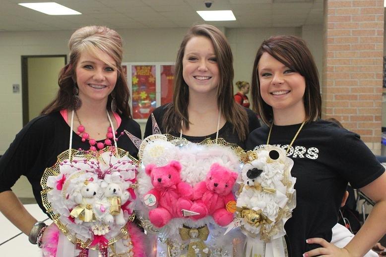 Seniors Bailey Pace, Emily James, and Mikayla Mitchell show off their mums for home coming.