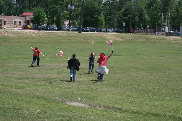 Panther Life students running with their flying kites.