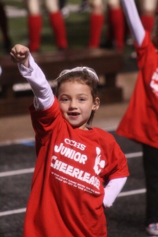 Junior Skylar Harris at a young age performing with Caney Creek High School cheerleaders at a football game. 