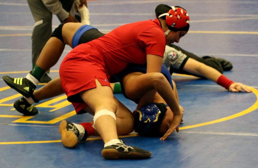 PINNED DOWN. Junior Linda Marroquin wrestles at the regional tournament Feb.15-16 at Pflugerville Weiss High School. Both Marroquin and senior Juan Martinez advanced to the state competition.