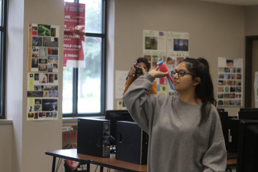 Junior Jackie Bahena throws a dart during a competition at newspaper camp, which she eventually won by eight points.