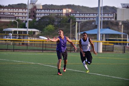  A player from the Frisbees of the 7 Seas passes to a teammate before an opponent from Netflicks & Chill can break up the play during an Ultimate Frisbee game July 19 at Cooper Field on U.S. Naval Station Guantanamo Bay, Cuba. 