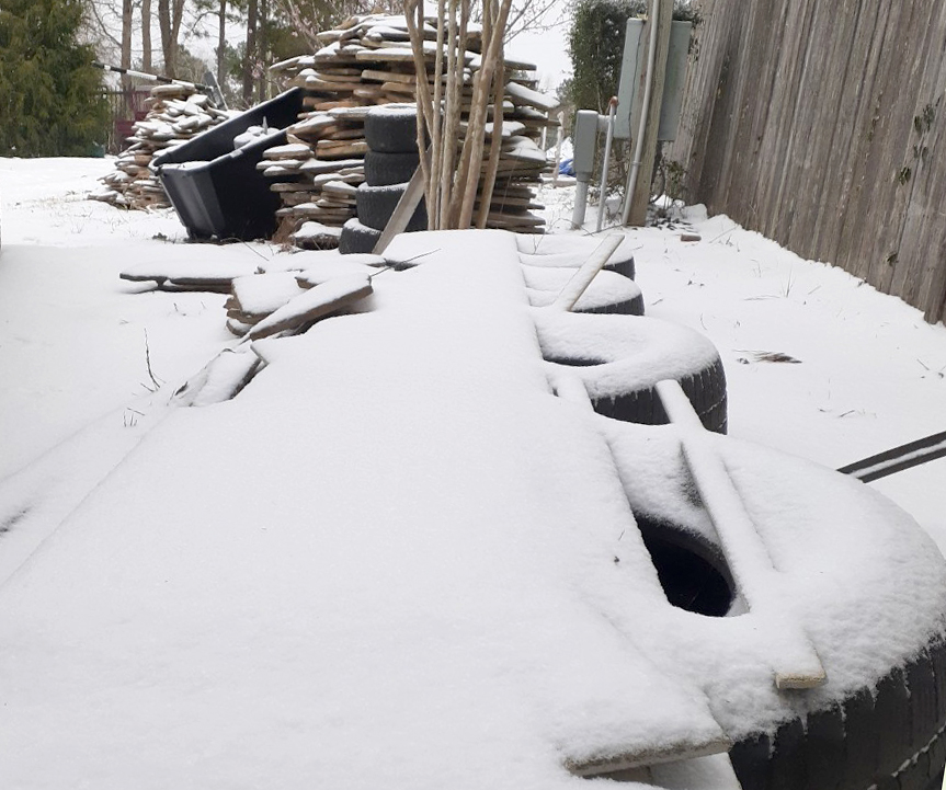 Snow covers a pile of construction materials Monday, Feb. 15 after a winter storm blanketed Montgomery County in ice and snow. 