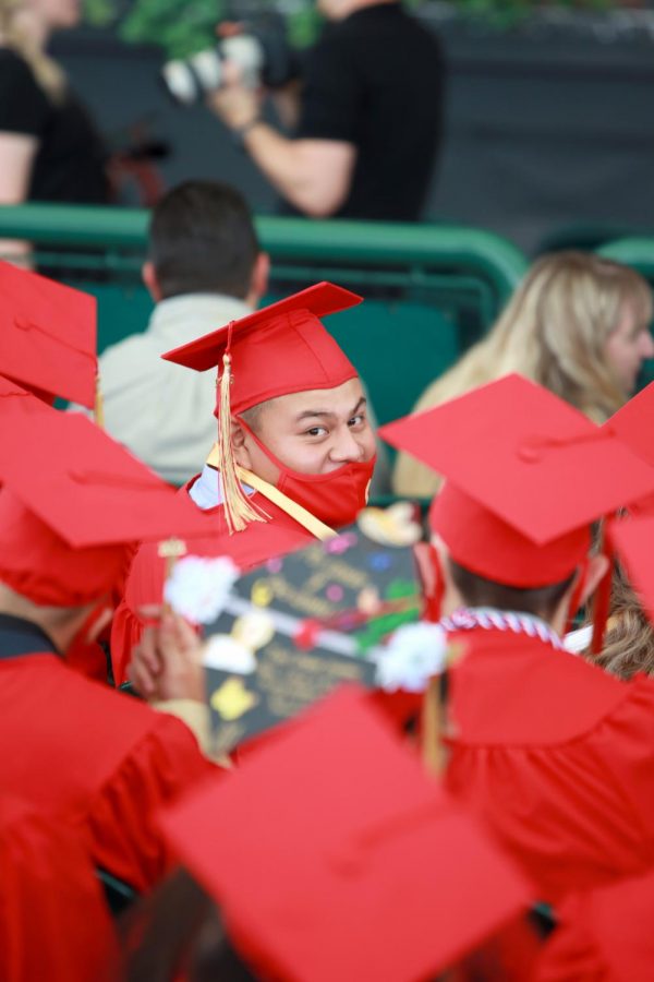 Samuel Gallaga turns to talk to a friend during the graduation ceremony at the Cynthia Woods Mitchell Pavilion on May 22. It was the first time Caney Creek graduated at a location other than Sam Houston State University.