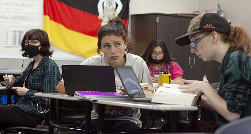 German students Alexa Mercado, Kyleigh Clark, Victoria Famer, and Leah Wallace, working on their assignment using the resources provided. When Wallace was asked about why she chose to wear her mask she said I chose to wear my mask because  I do have high risk family members, and I would like to protect them and myself and other people.