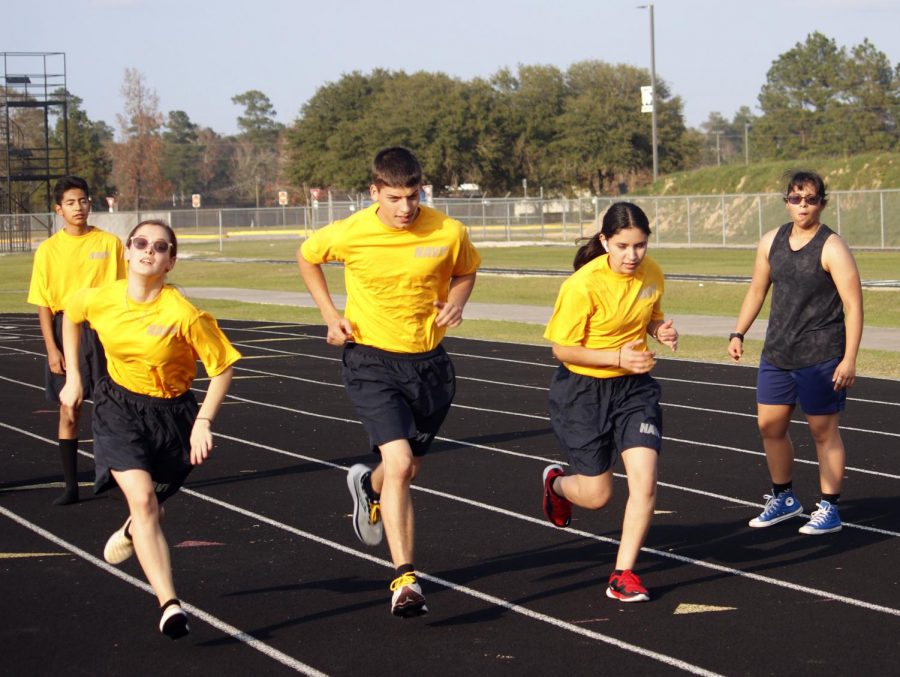 Kayla Jaca, Ian Leblanc and Summer Widemon dash towards the finish line as CItlalli Ramirez watches for the results.  