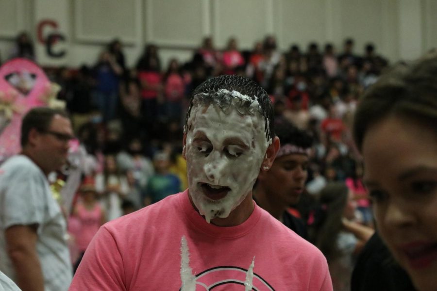 Nicholas Moore gets pied in the face at pink out pep rally.