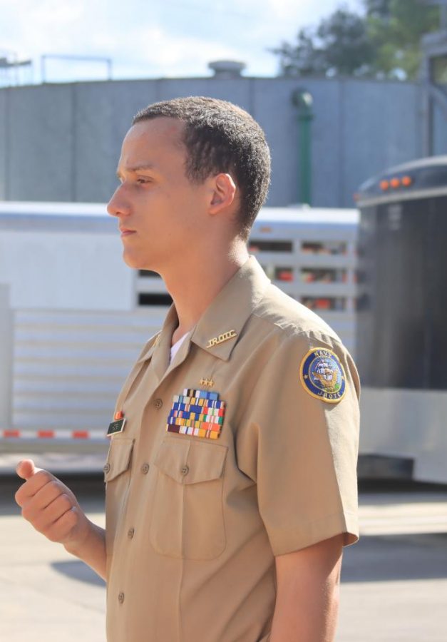 Zechariah Hoops is giving advice to one of his fellow cadets about spinning the riffle. 