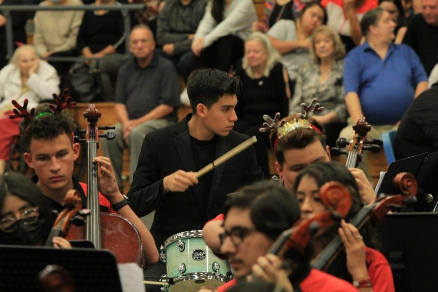Alejandro Valdez is the only drummer but is helping with the background  beats in the orchestra performance