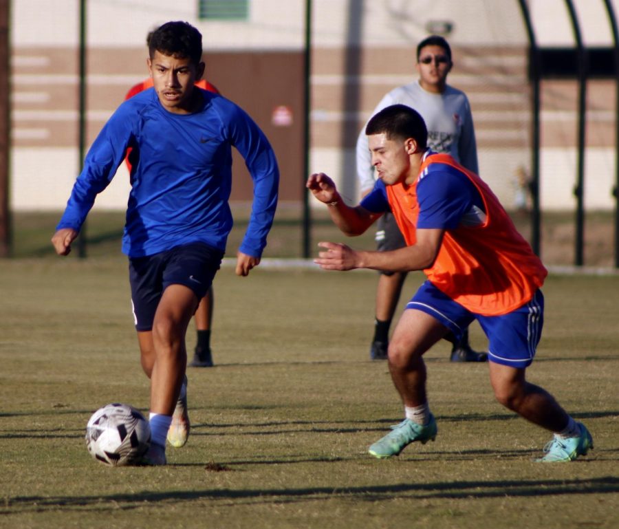 Freshman Erik Carbajal running away from the penalty area to defend his goal meanwhile junior Fernando Gomez tries to steal the ball. 