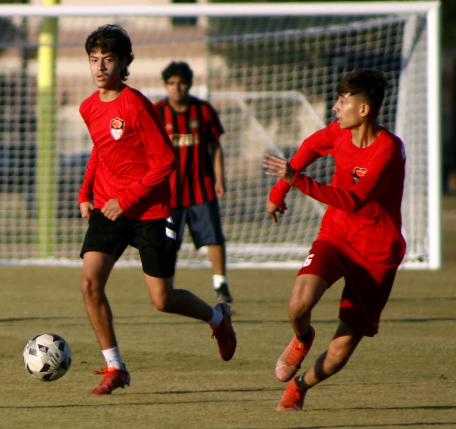 Sophomore Brayan Lopez signaling Freshman Emmanuel Gloria to pass him the ball.