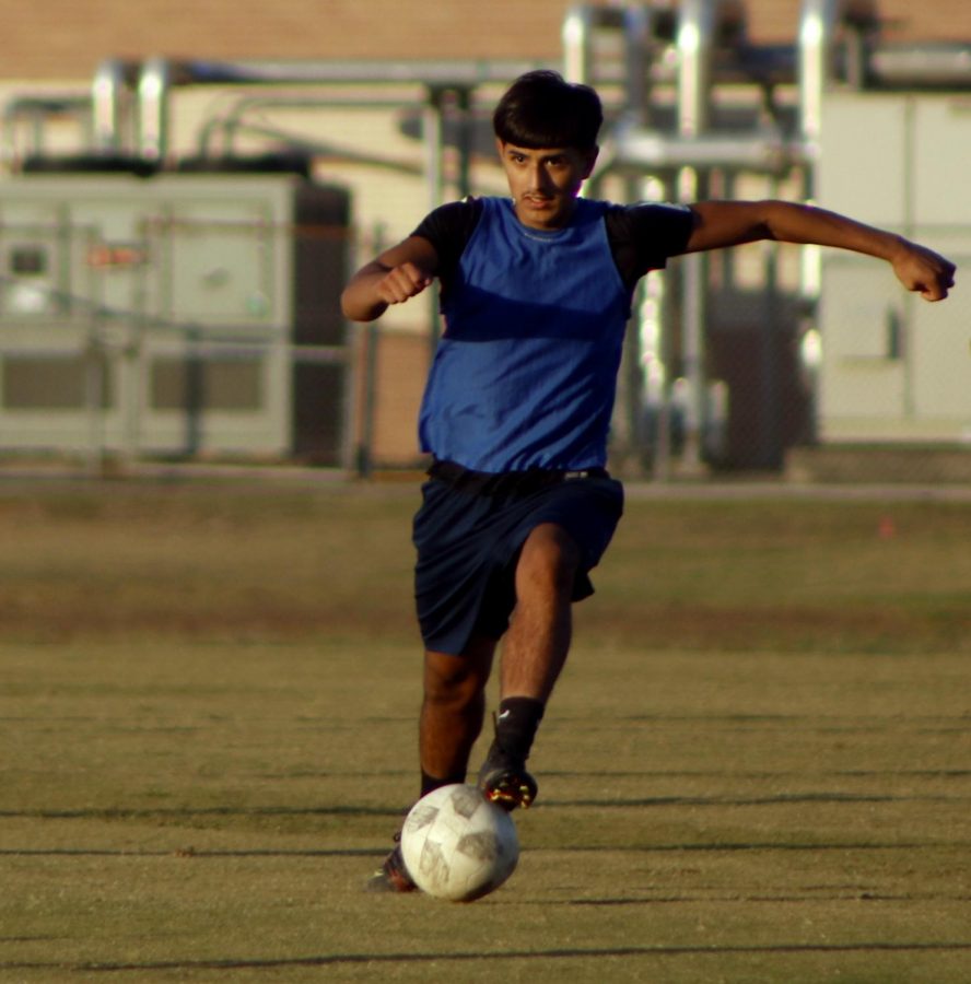 Freshman Rudy Mateo power running with the ball towards the goal. 