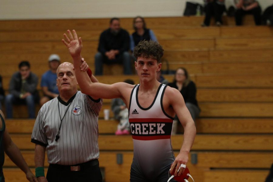 Senior, Jacob Nance, waves to crowd after winning his second match. 