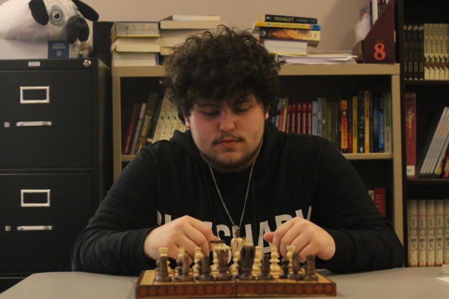 Adam Northworthy (12th) who has been playing chess for years. He  currently setting up the  chess board for his next opponent Jose Gomez
