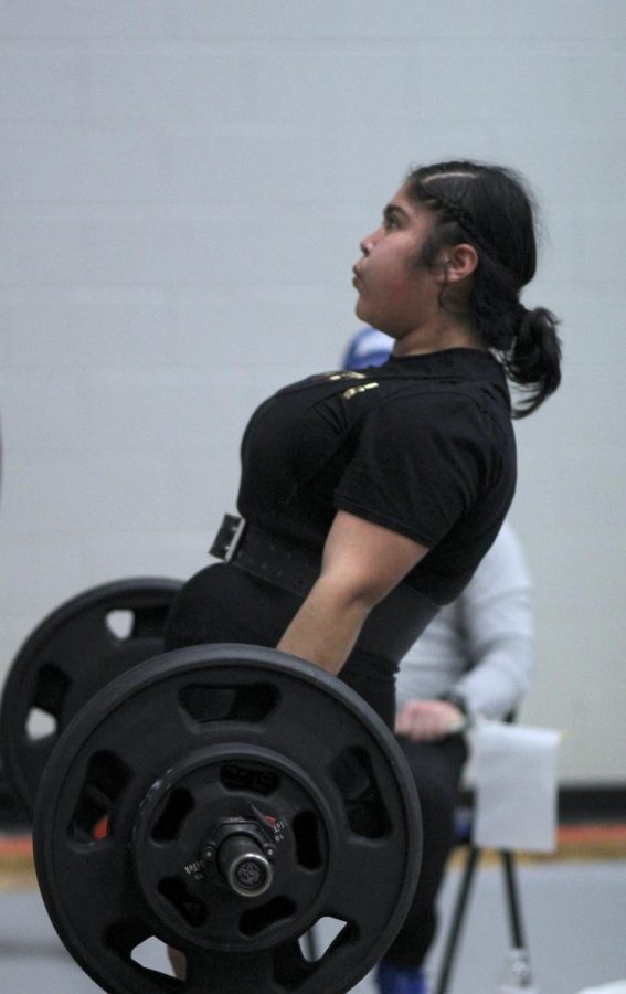 Junior Alinne Flores deadlifts 300 on her third attempt.”It was the first meet after Coach Cauley had left so I was really nervous. I didnt get my 385 squat so I was stressed too at that point, but I placed first. Im very happy with how much Ive grown since then.” she said..