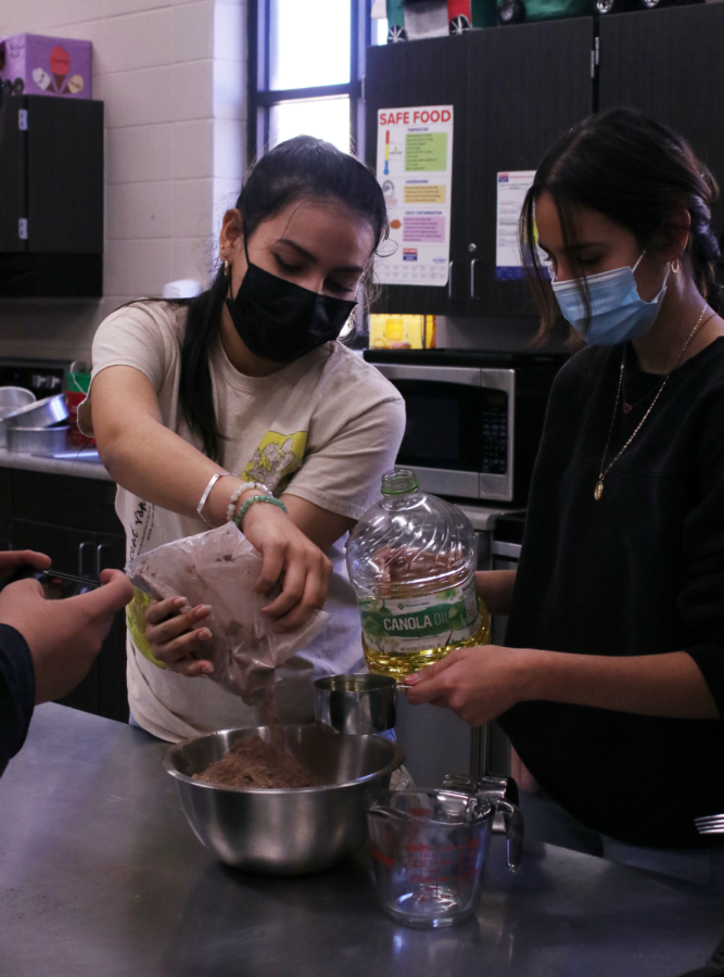 TIME TO GET STARTED: Lucero Zambrano (10) and Nancy Hernandez (11) putting ingredients into the bowl to be mixed.