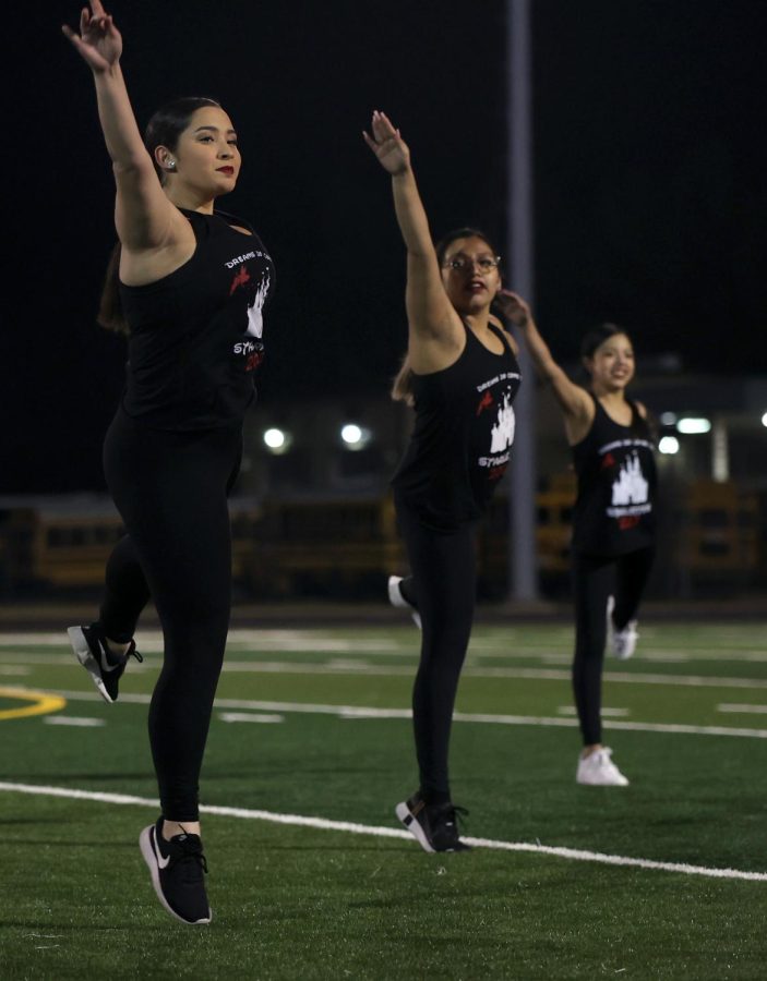 Adrianna Garzoria [12], Lieutenant Colonel, dancing with Angelina Cervantes [12], Vice President, while performing a Disney show at halftime in the girls soccer game against Cleveland. 