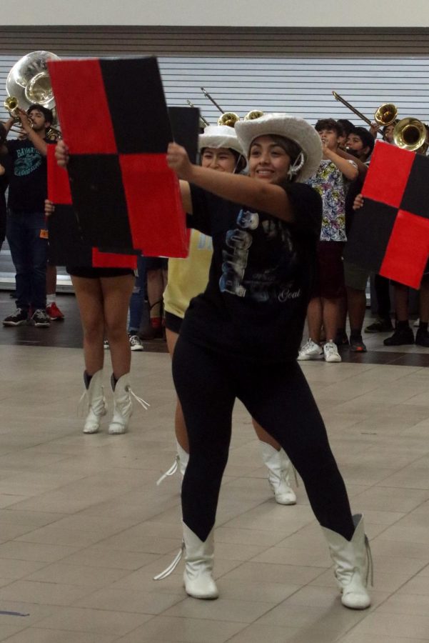 Julissa Hernandez [12], line member, dances with the Starlettes while doing a military dance after school with band. 