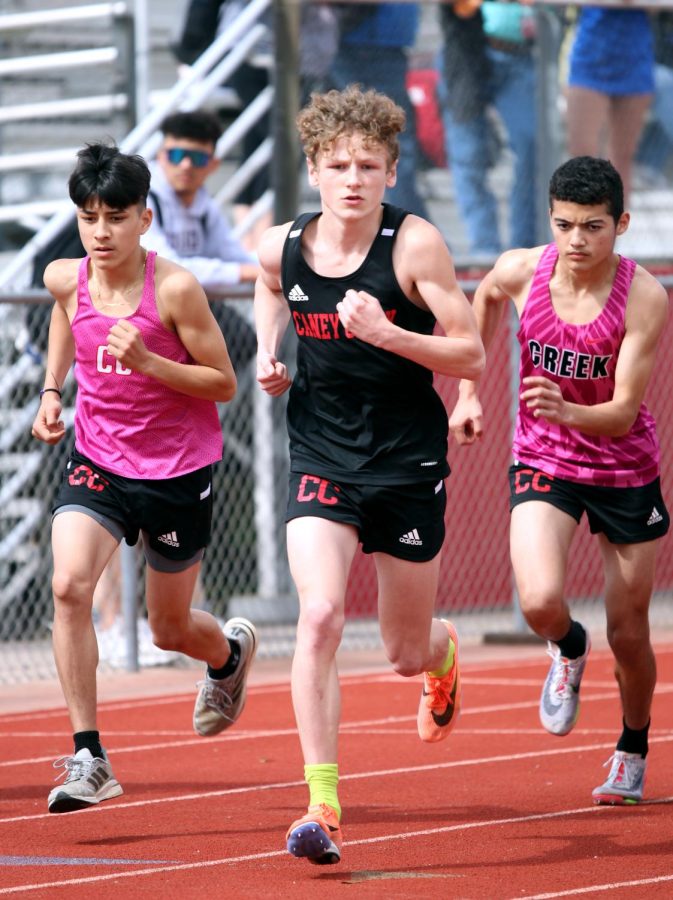 The Varsity track boys push themselves to the finish line. 