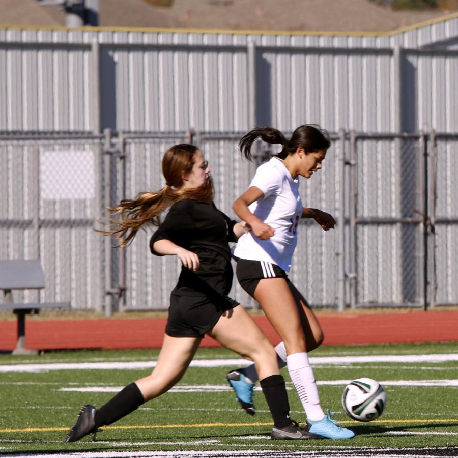 Emily Jimenez (11) dribble past Kingwood Park player.