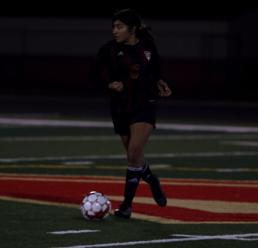 Alejandra Aguilar (11) Defender stops the ball and passes back.