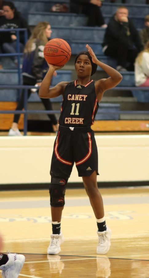 Varsity player Angel Lindsay (12) preparing to shoot against New Caney.