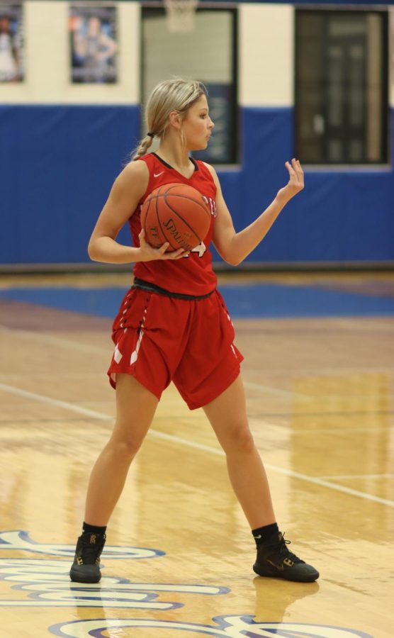 Freshman Megan Shreck uses hand signs to call over her teammates so she can pass the ball.