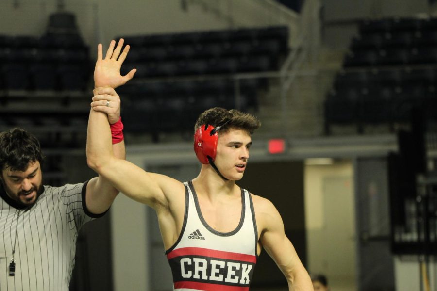 Senior+Josh+Thomas+getting+his+hand+raised+after+pinning+his+opponent+in+the+UIL+District+12-5A+160+lb+weight+class+finals.+