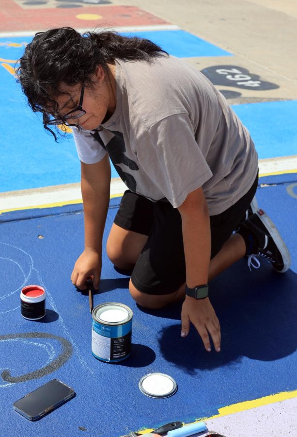 POP THE TOP. Senior Jocelyn Gonzalez opening a new can of paint on Saturday, Sept. 17, 2022. It was hot, but I felt happy that I was a senior and felt cool that I finally got to do it, Gonzalez said. I just wanted to put my favorite thing which was Pokémon and Superheroes, and wanted to keep my sisters parking spot, and even if she graduated shes still a part of this school and my life. Was a big inspiration for Jocelyn’s design on her parking space. (Photo by: Michelle Santoyo)