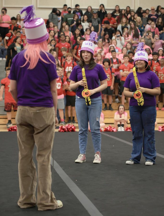 CARELESS WHISPER. Sophomore Daniela Vargas and Senior Stephanie Martinez and others from the Caney Creek theater dresses as Willis band students and perform Careless Whisper by George Michael for the pink out pep rally on October 14, 2022. 