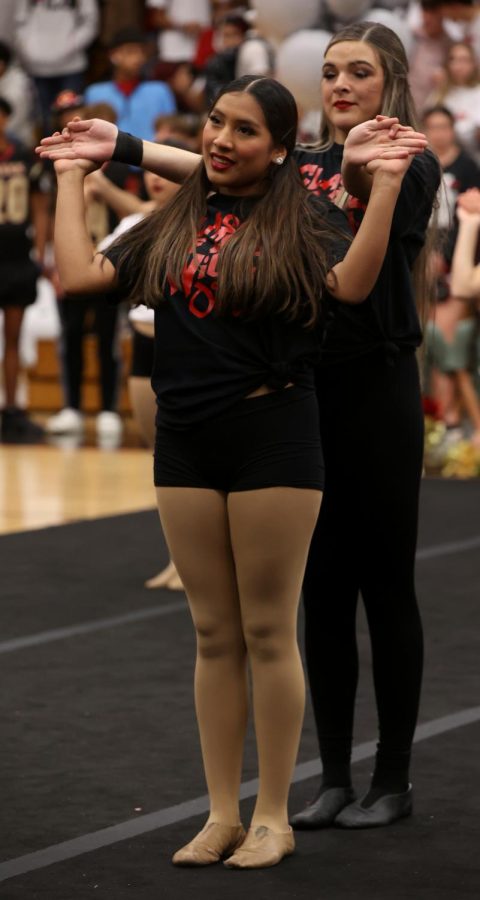 LAST DANCE. Senior Aracely Rostro holds Senior Cloie Peters hand as they dance with the starlettes in the last fall pep rally in the performance gym on Oct. 28, 2022. Rostro and Peters have been in the Starlettes Drill Team for 4 years straight and have grown together from line members to lieutenants. “I enjoy dancing with her,” “It hurts that us dancing together is coming to an end.” Peters said. “Dance was definitely a good decision and one I will forever be grateful for.” Rostro said.