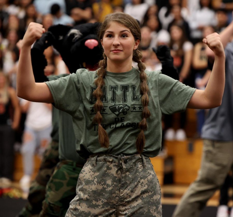 PUMP IT UP. Senior Cali LaCaze poses while dancing to cheerleaders performance as they honor those who have fought in battles on Oct. 28, 2022 in the Caney Creek Performance Gym. “I love the way we support everyone else,” LaCaze said.