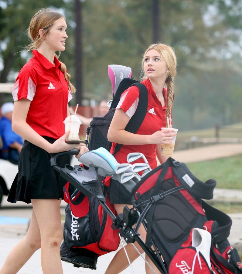 THE START. Freshman Holly Wood and Freshman Jadynn Pierce talk while walking to the warm up section of the Grand Oaks golf course on Nov.7, 2022. Wood and Pierce are the only girls currently representing Caney Creek girls golf since 2020. Ever since Covid there hadn’t been girls in golf, and now after two years there’s girls Golf . “I feel like me and Jad can be the start of growing something new,” Wood said. “We can spread the word, and build into something bigger.”
