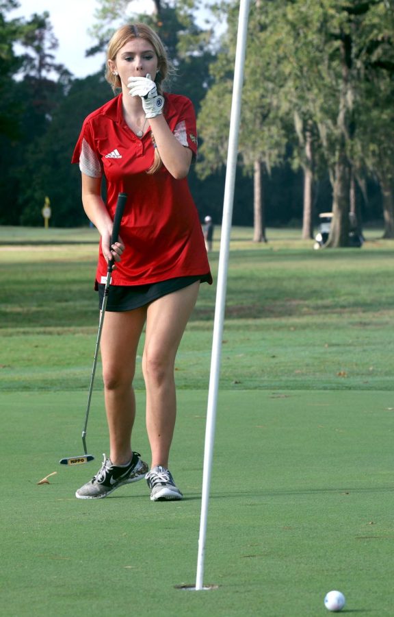 HIT AND MISS. After missing her putt Freshman Jadynn Pierce covers her mouth in shock at a Grand Oak tournament Nov. 7th, 2022 Pierce was frustrated. She kept missing the hole and  wouldve missed par and maxed out, but after re-putting at her sixth stroke on a par five, she settled herself. A par is the amount of strokes a golfer needs to have to get a good score on a hole, golfers try not to max out to keep their scores lower. “I was ok with getting a 6, when I lose I practice what I did wrong,” Pierce said. “I practice to get better and get better scores.”

