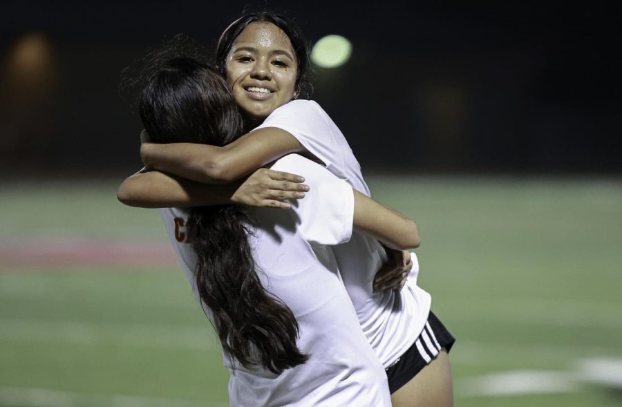 VICTORY HUG. Sophomore Leila Chicas hugs Senior Lilian Sanchez after their win against Cleveland High School. Going against Cleveland again was an intense game as Chicas would describe. After their win, she ran towards Sanchez to congratulate her. “Lily was playing very well and I was proud of her,” Chicas said. “She did most of our goals with a penalty kick and a header.”
