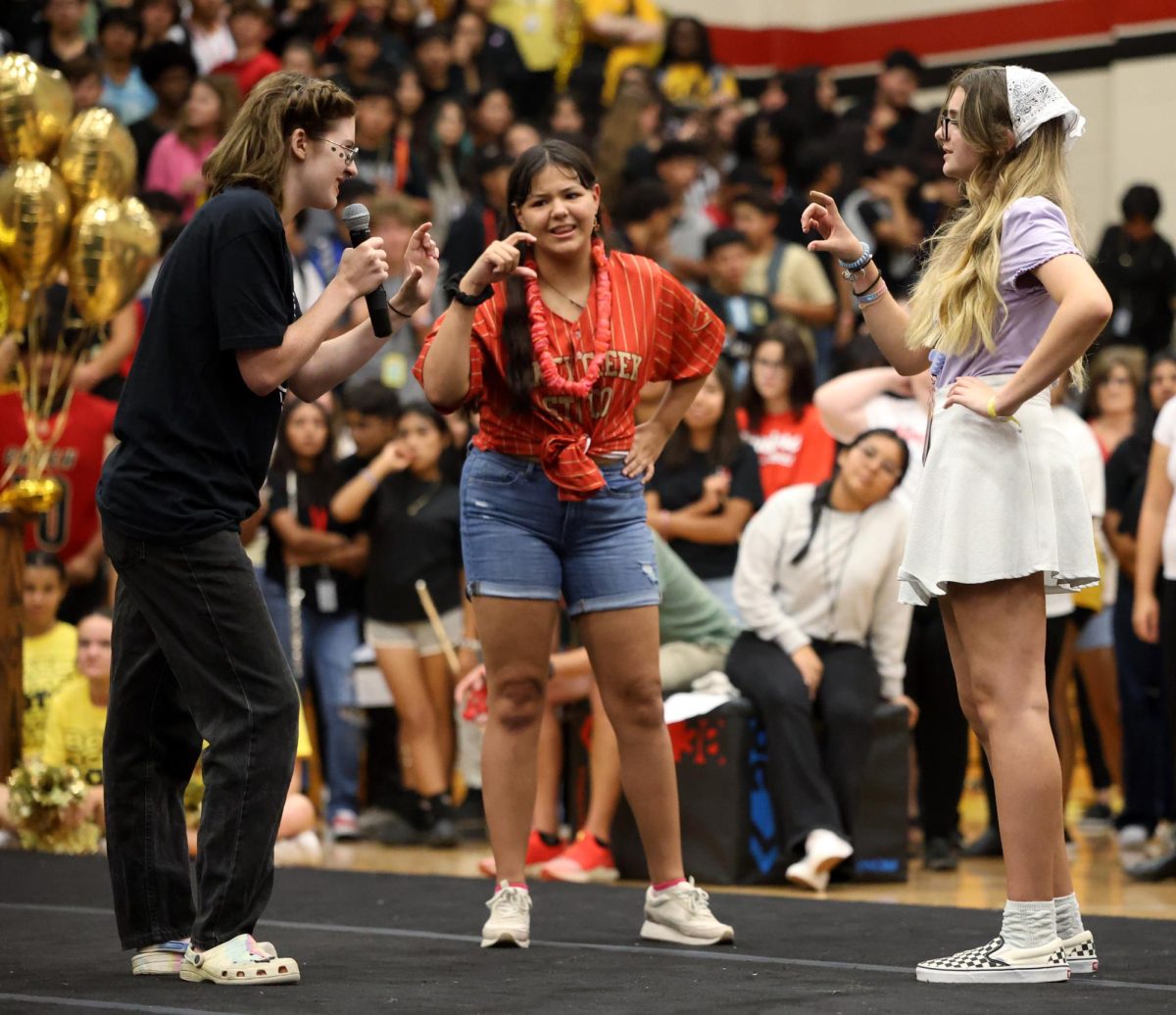 AND ACTION.	 Senior Sophia Schaloff and Juniors Amberleigh Alvarez and Sophomore Cara Bettes perform a small skit for entertainment during the pep rally on Sep.15, 2023. The act was originally going to be different but was modified and changed. “I was scared because obviously I was performing in front of a ton of people, and I had just learned the lines,” Schaloff said. “Even though I was a bit scared, it was still a very fun experience.”