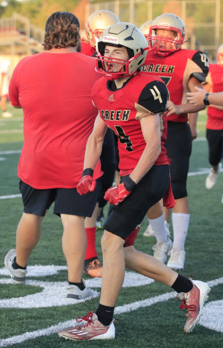 LETS GO. Freshman Rayden Peroni celebrates the good play that he did on Thursday, Sep. 21, 2023. Peroni plays as a quarterback and as a wide receiver throughout the game, after receiving a successful pass and moving closer to the end zone they celebrate.