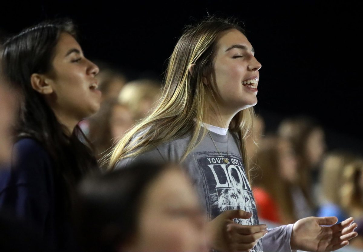 SAINTLY DEVOTION. Northern Houston Christian students embrace the live musical performances on Wednesday, Oct.18, 2023. The audience would sing along to the christian anthems with grace and compassion in between speakers and student led accounts on their experiences as a Christian. 