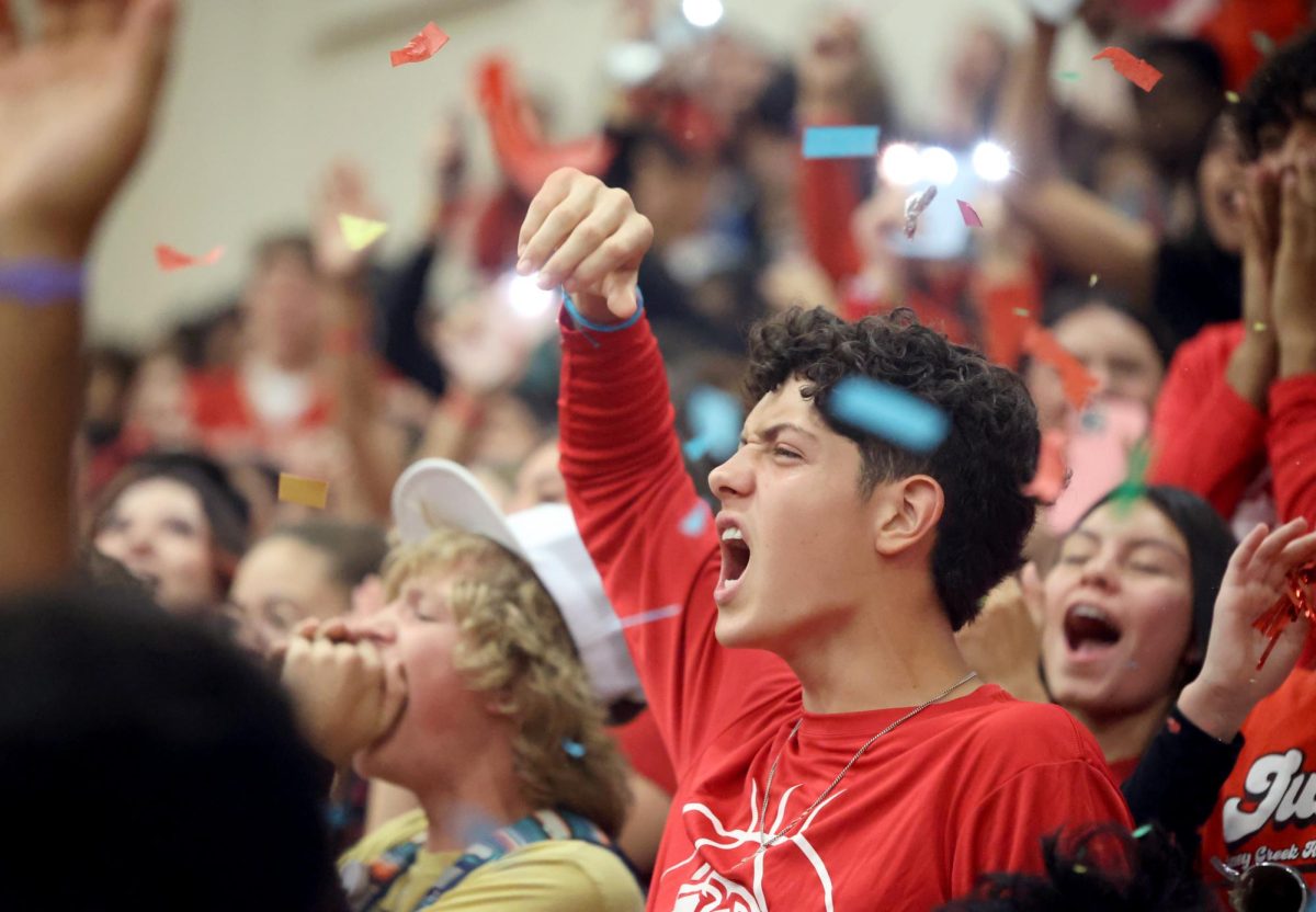GO CREEK!. Junior Derek Darkenwald yells during the junior class victory chant at the red out pep rally on Friday, Sept. 29, 2023. All grade levels chant “V-I-C-T-O-R-Y” the loudest in attempts to win the spirit stick for that pep rally. Despite his efforts the senior class won the stick instead. “If youre not there to participate there is no point in you being there,” Darkenwald said. “It is gonna be boring if you just stand and sit there.”