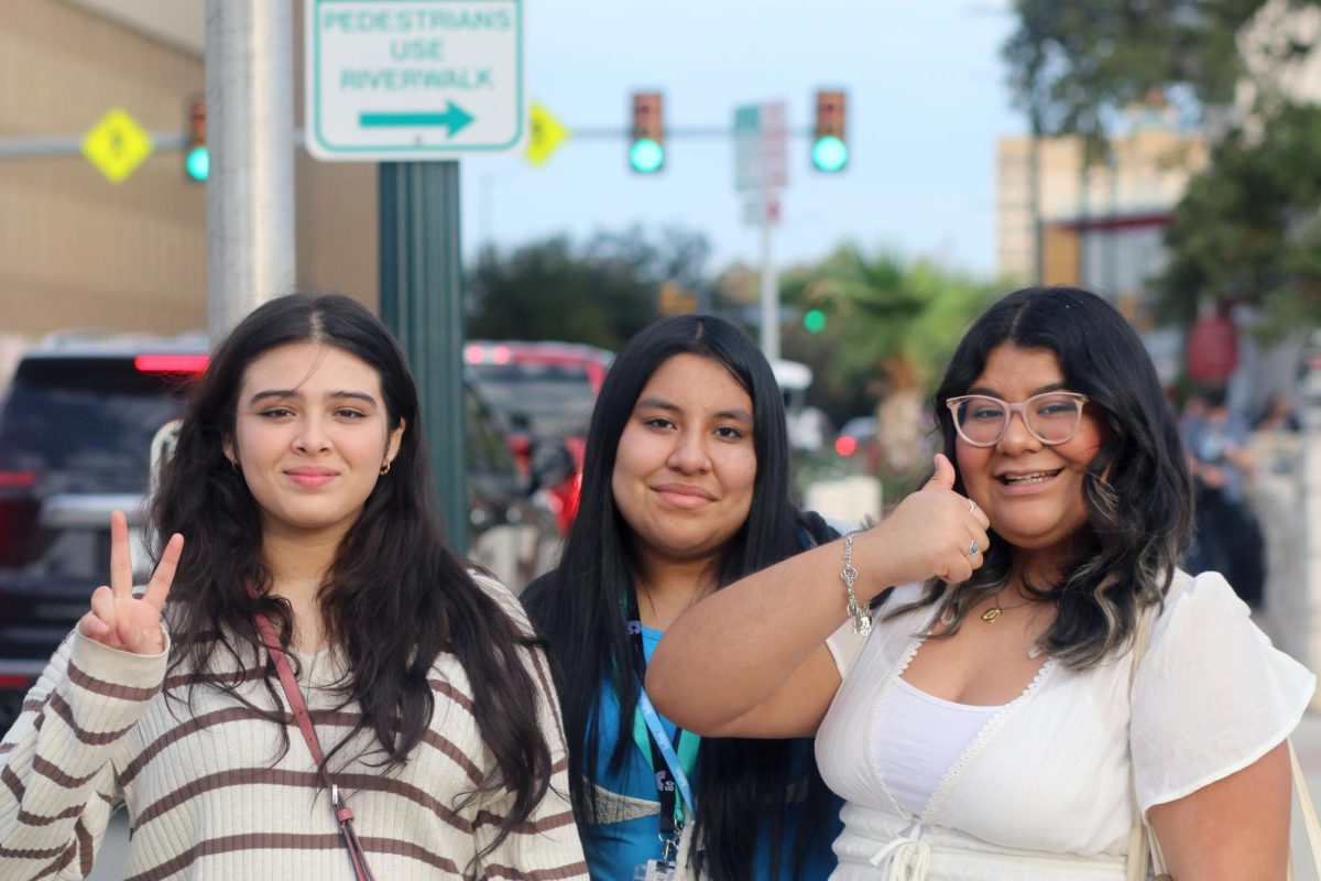 THUMBS UP AND CHEESE. Seniors Angelica Jasso, Jennifer Zuniga and Junior Yovana Sanchez pose as they stand in a street at San Antonio on Saturday, Oct. 7, 2023. Photographers who attended TAJE Fall Fiesta had the opportunity to explore the city to take pictures while partaking in contests.