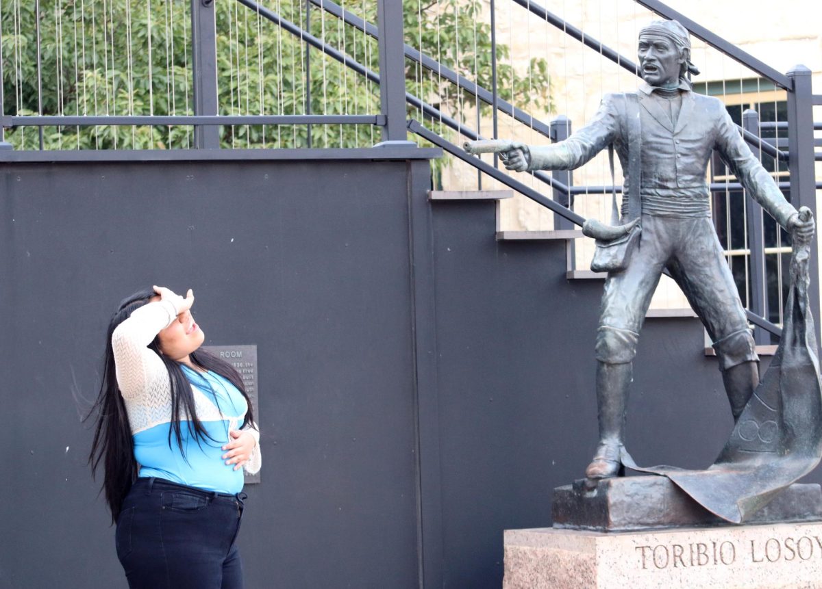 OH NO. Junior Yovana Sanchez poses as she pretends to be hit by the man in the statue in San Antonio on Sunday, Oct. 8, 2023. Members of Student Media got to walk around and discover the city during lunch before having to regroup to resume classes at the TAJE Fall Fiesta. I don’t usually take pictures but we saw this statue and I thought it was cool so we took a picture. It was so much fun to go out and be able to take pictures in the city,” Sanchez said. I usually never go out or do anything, so this was new for me.”